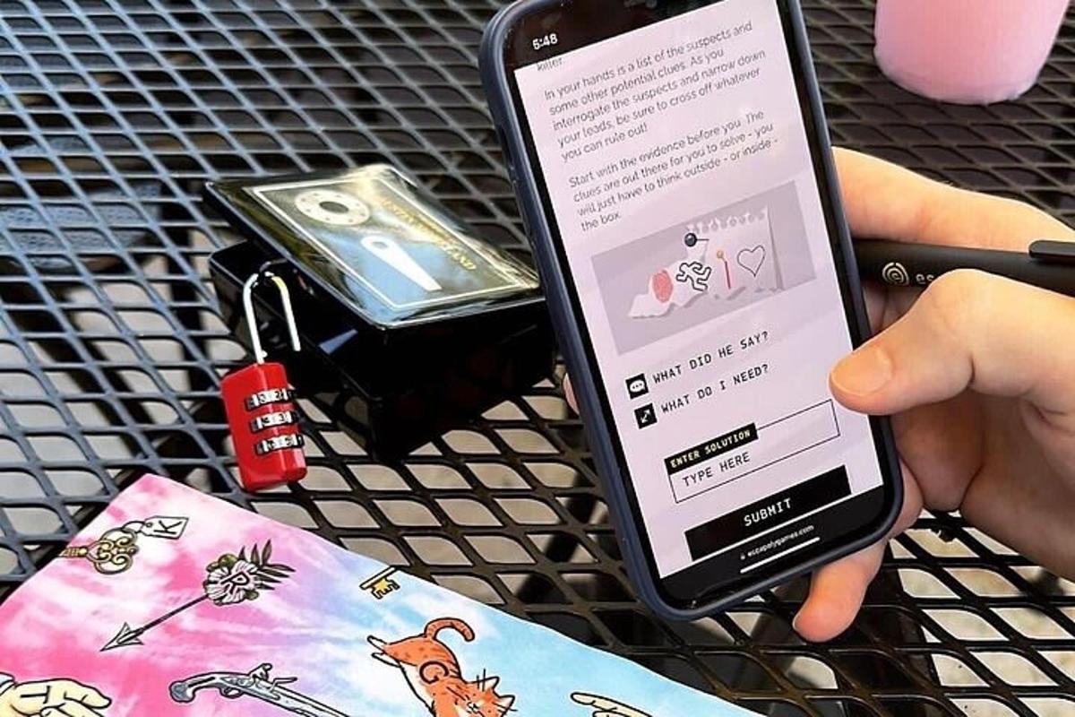 a person holding a cell phone next to a purse