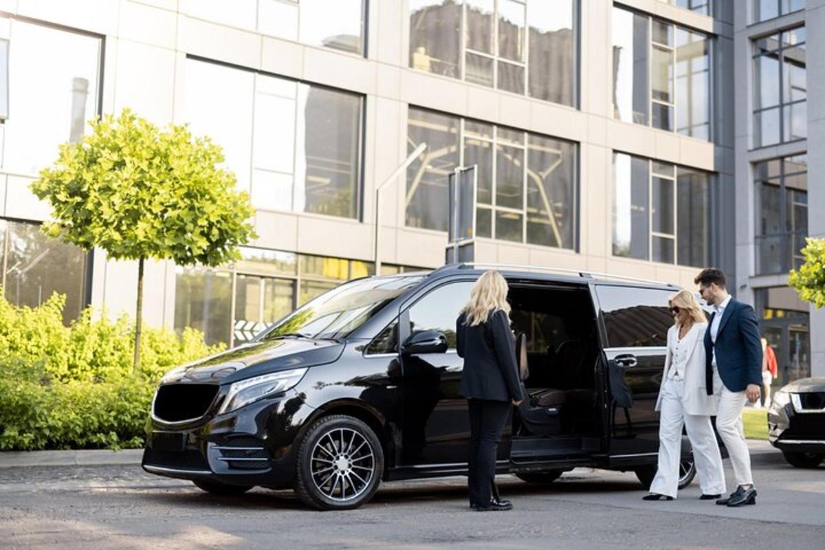 a group of people standing next to a car