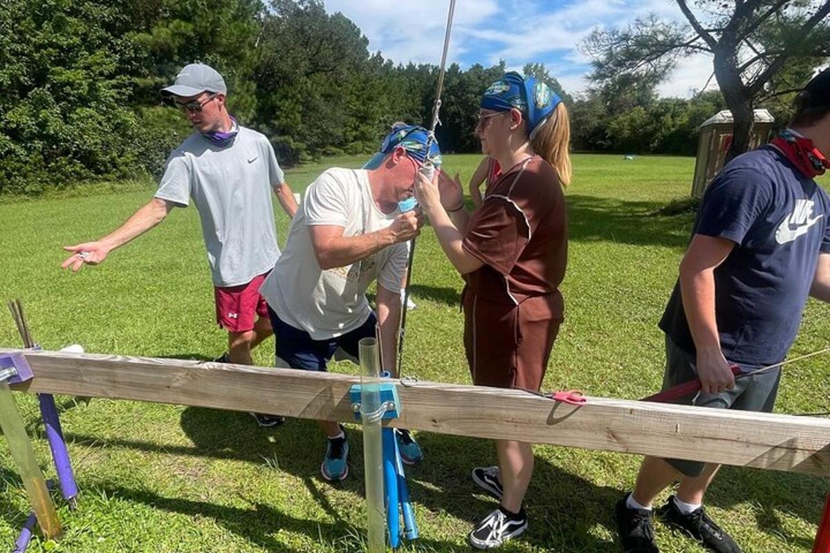 a group of people standing around a wooden fence