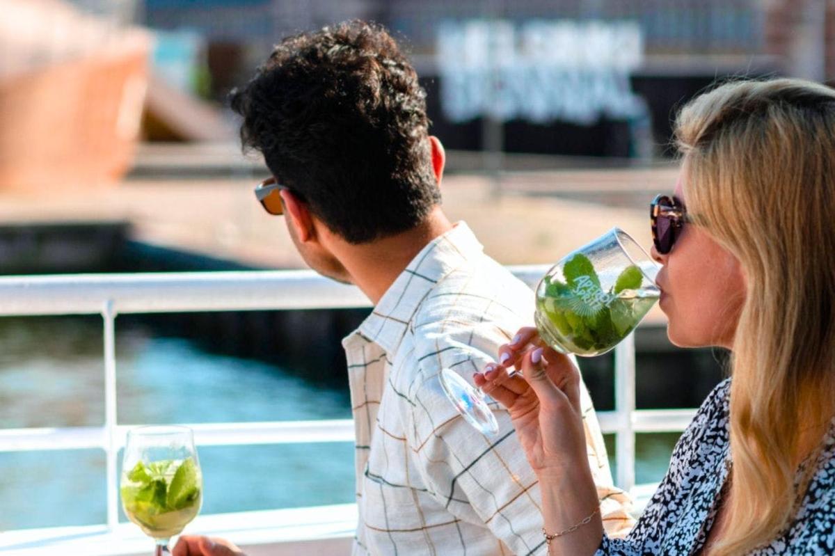 a woman holding a glass of wine next to a man