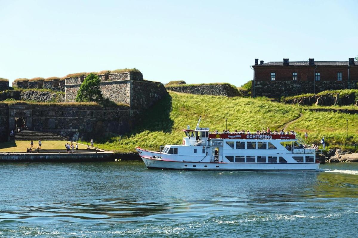 a boat in the water in front of a castle