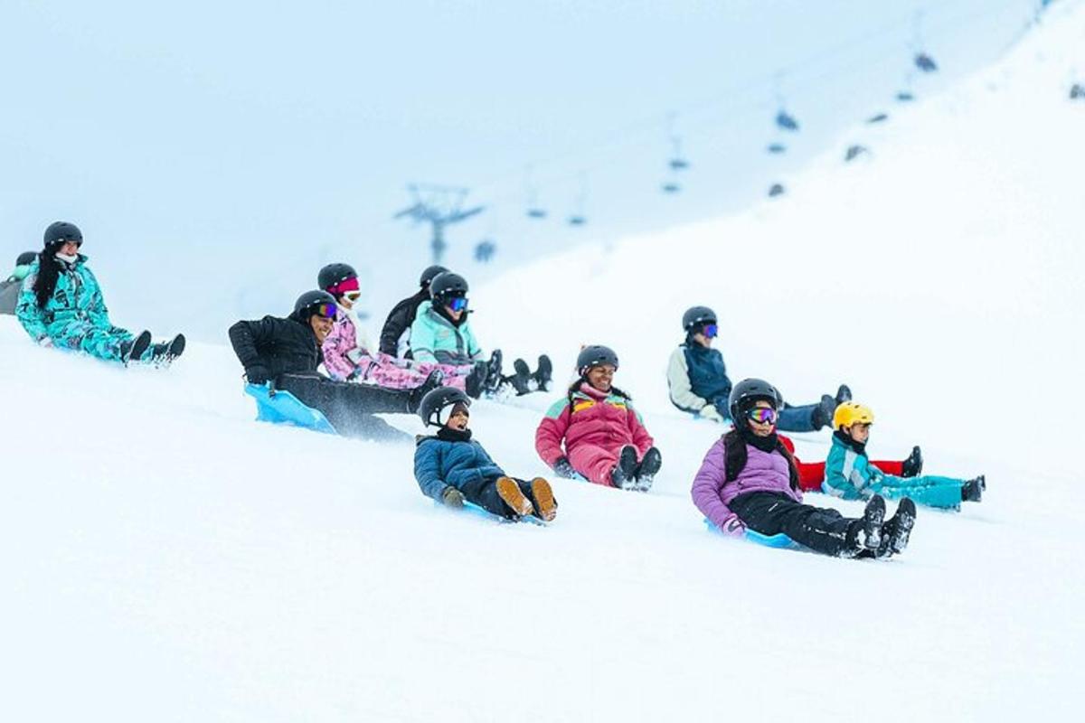 a group of people sitting in the snow on snowboards