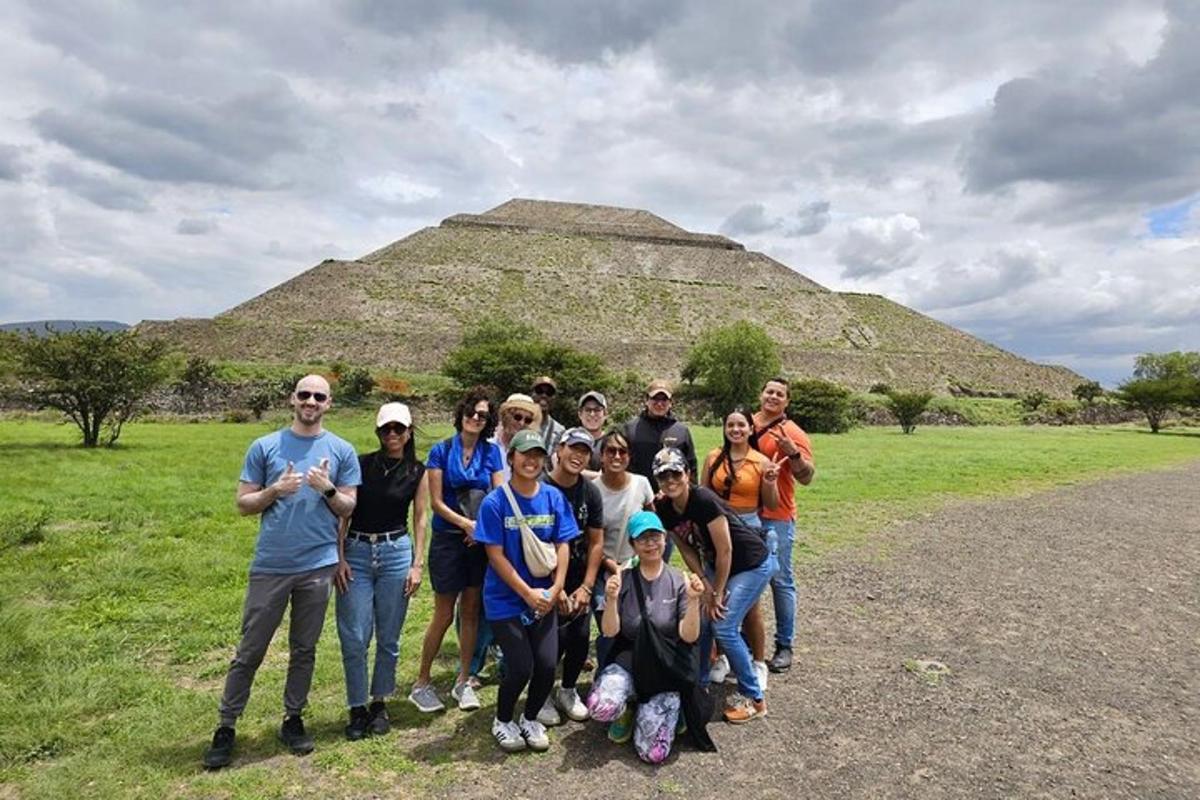 a group of people posing in front of a pyramid