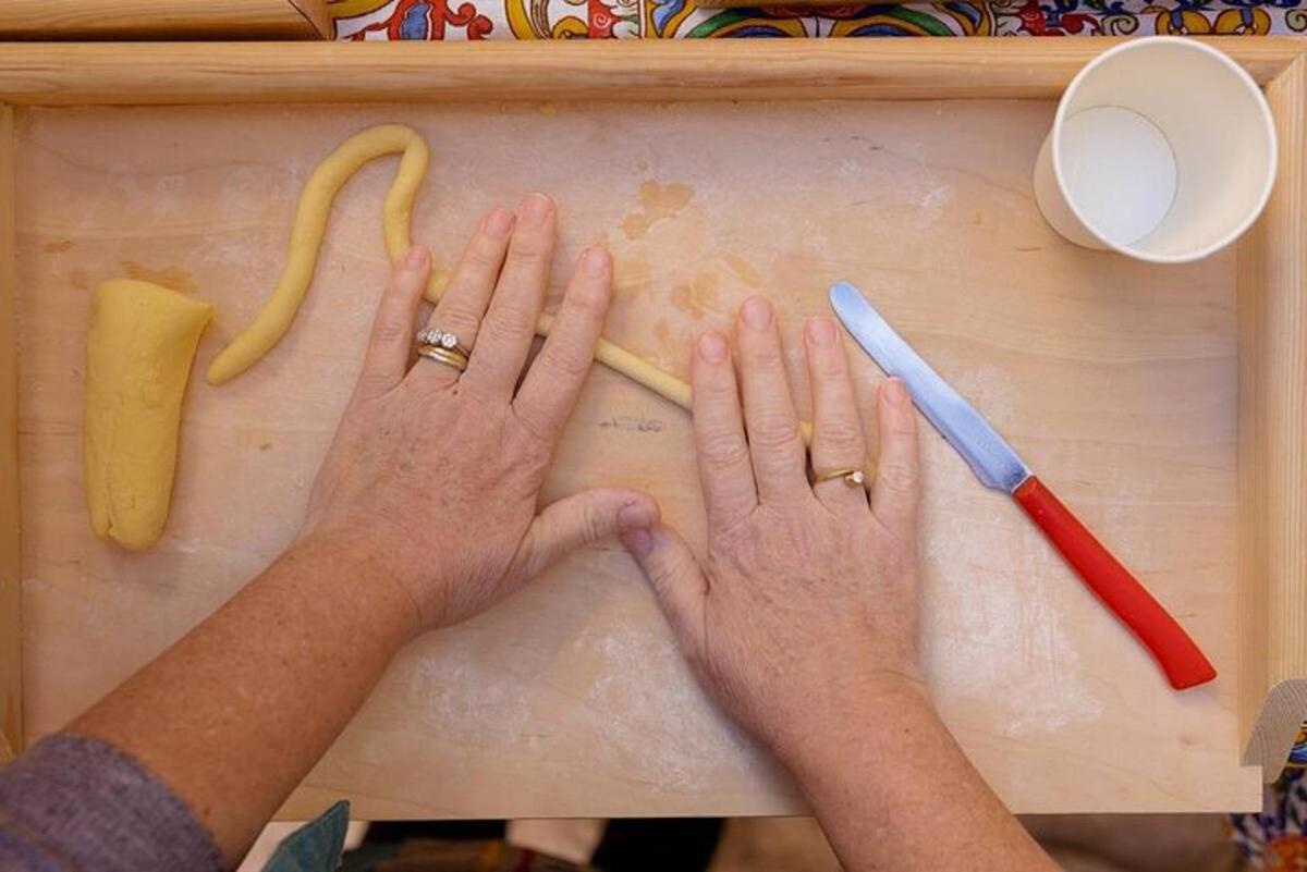 a person with their hands on a cutting board