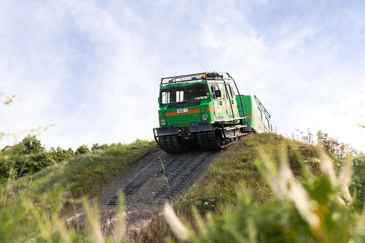 a green train is going down a hill