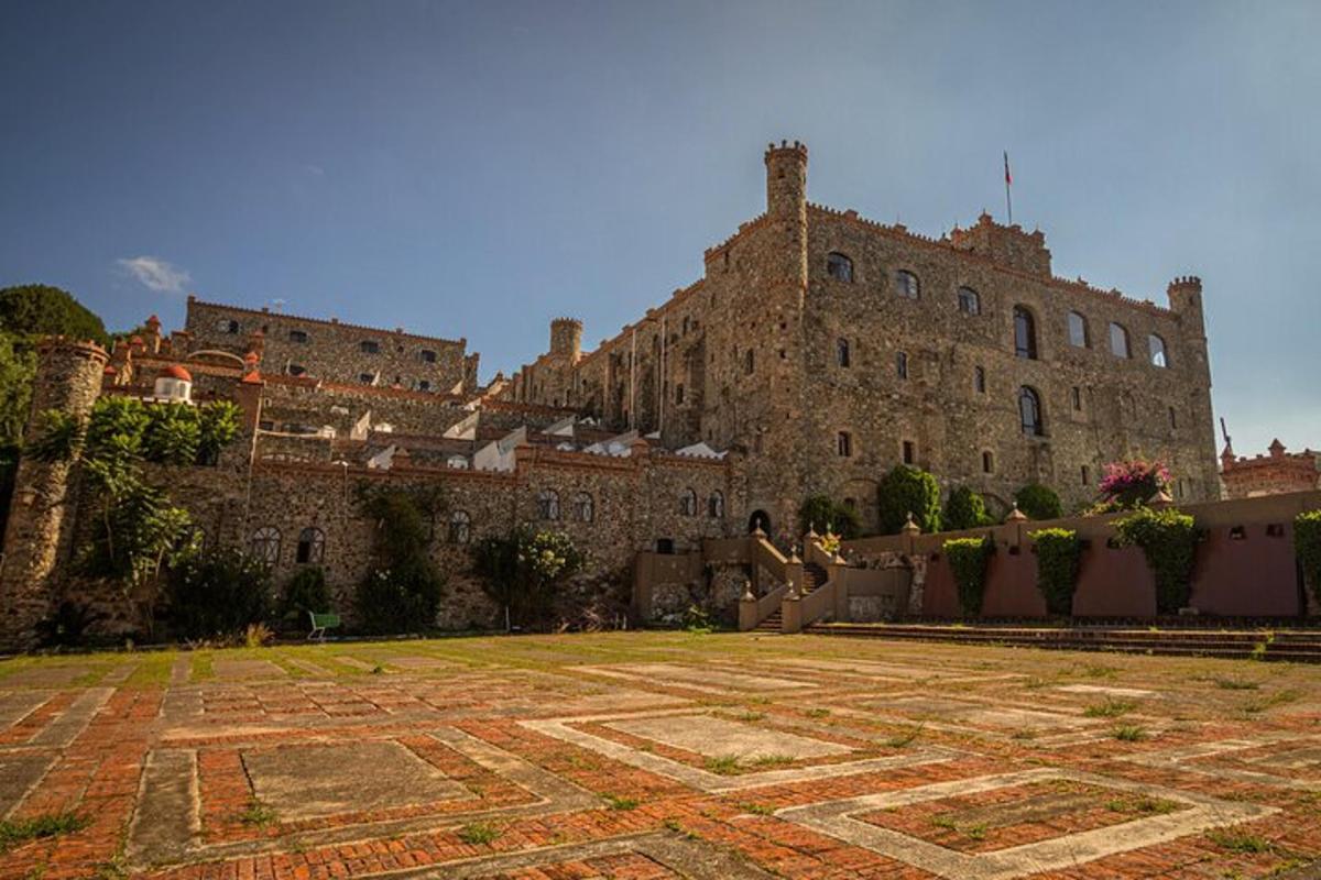 a large castle with a large yard in front of it