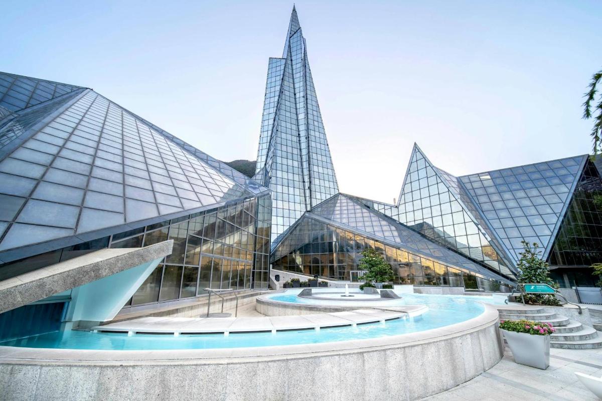 a large glass building with two tall skyscrapers