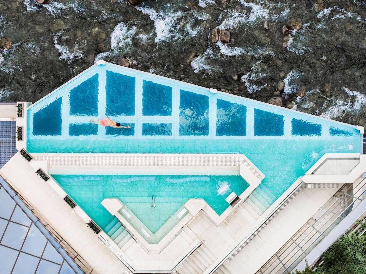 an overhead view of a swimming pool with a person in the water