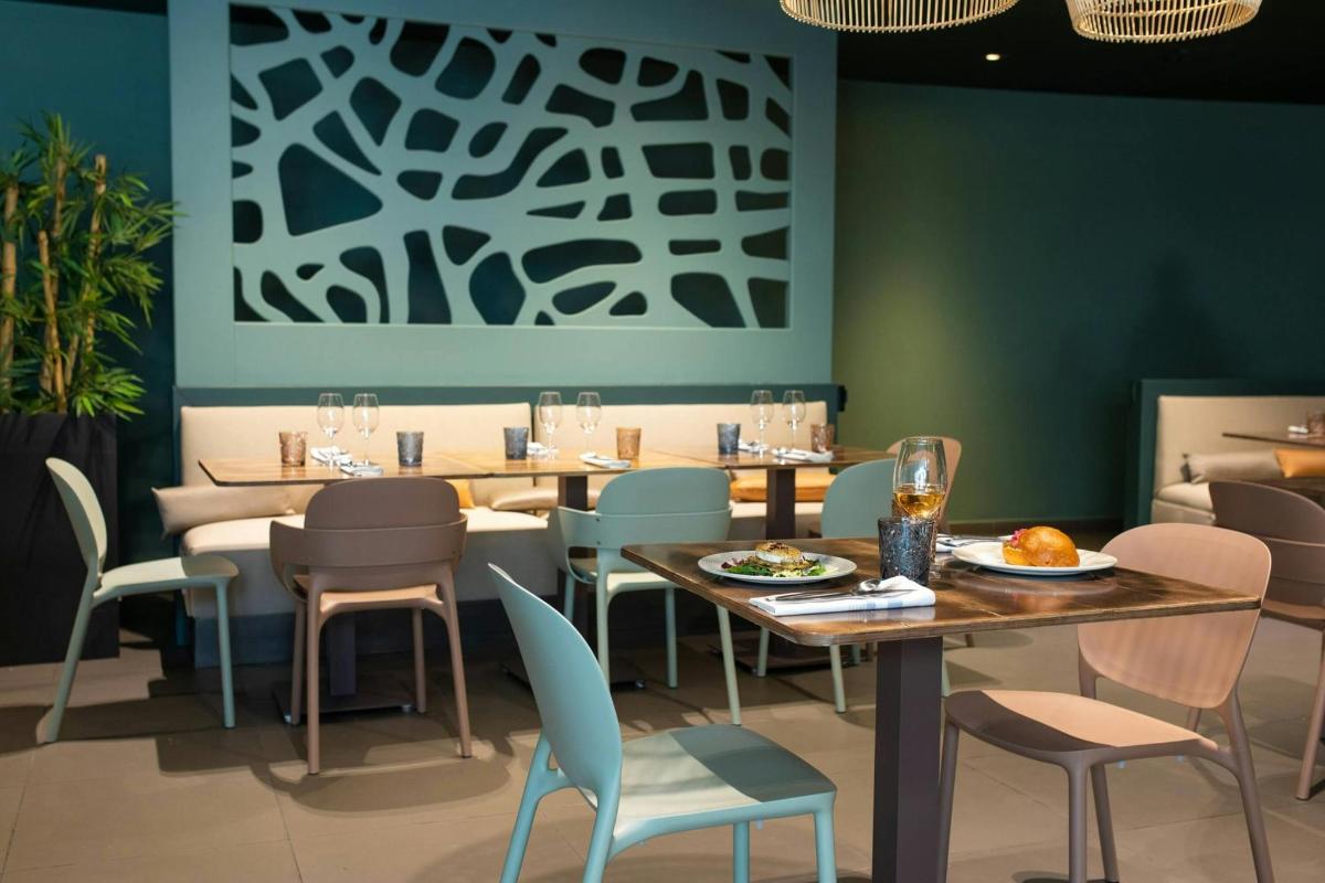 a dining room with tables and chairs and a painting