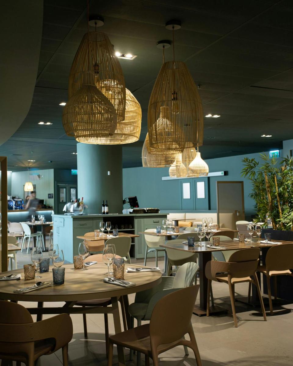 a dining room with tables and chairs and lights