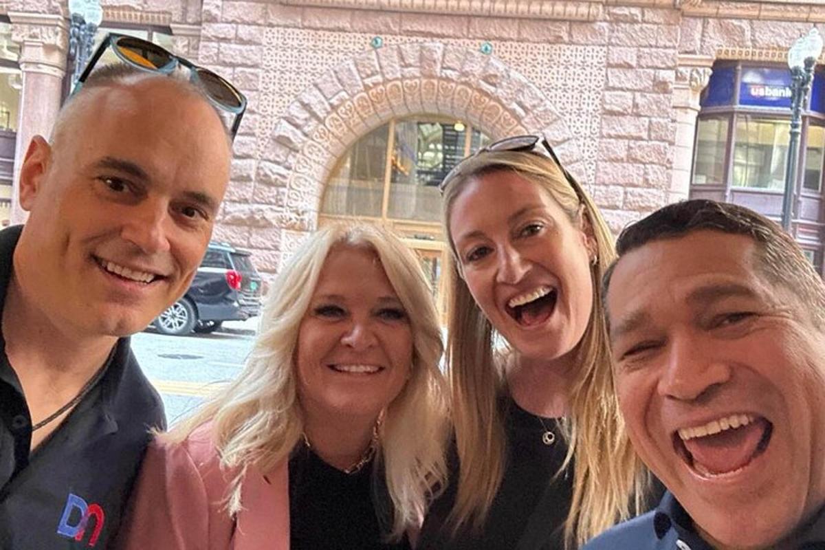 a group of three people posing for a picture