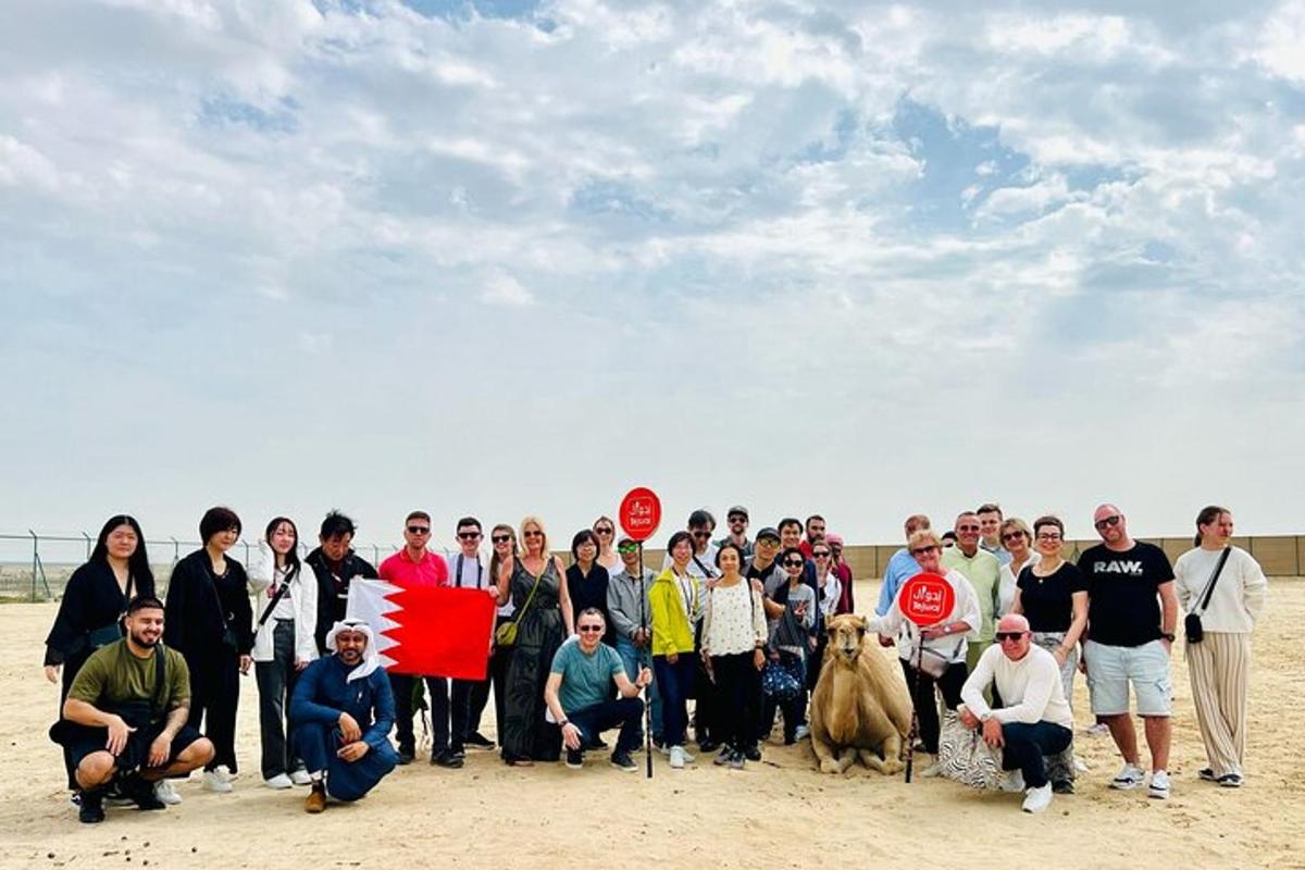 a group of people posing for a picture on the beach
