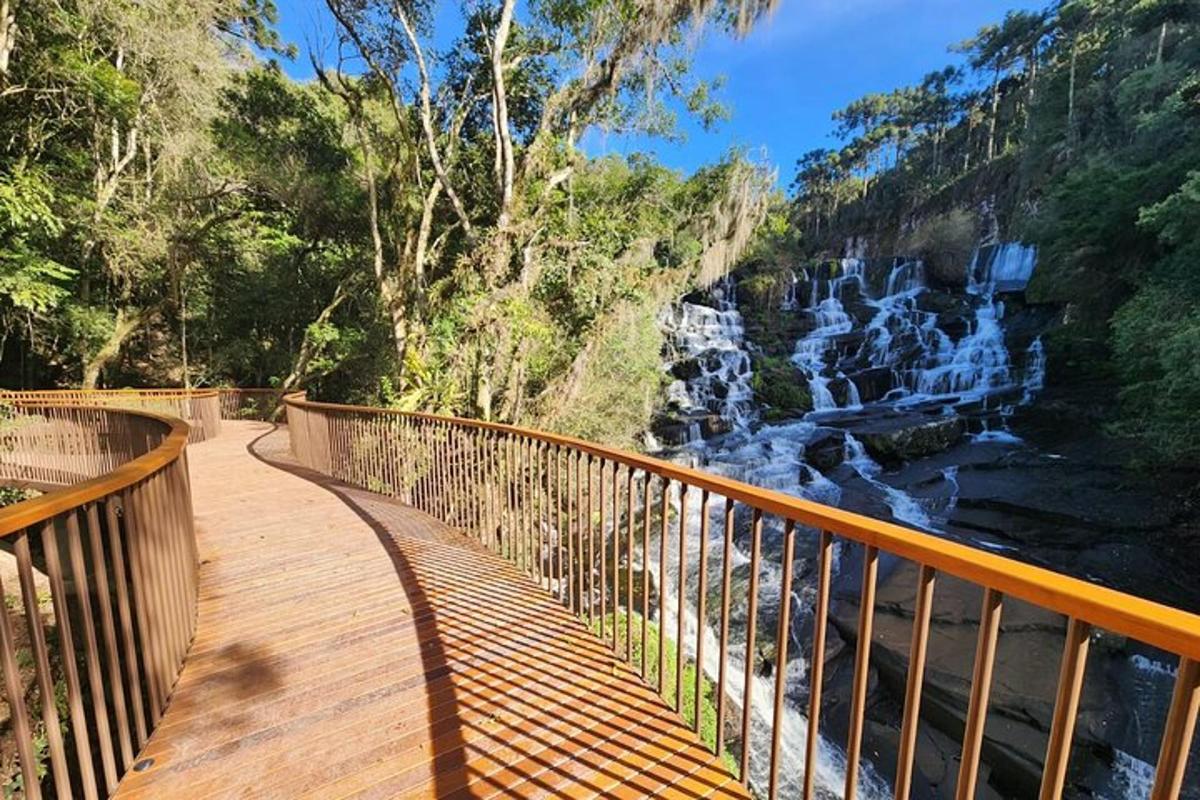 a wooden walkway with a view of a waterfall