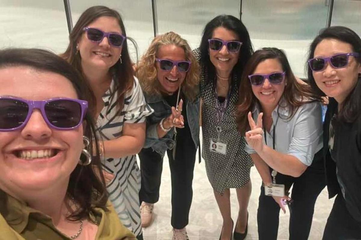 a group of women in sunglasses posing for a picture