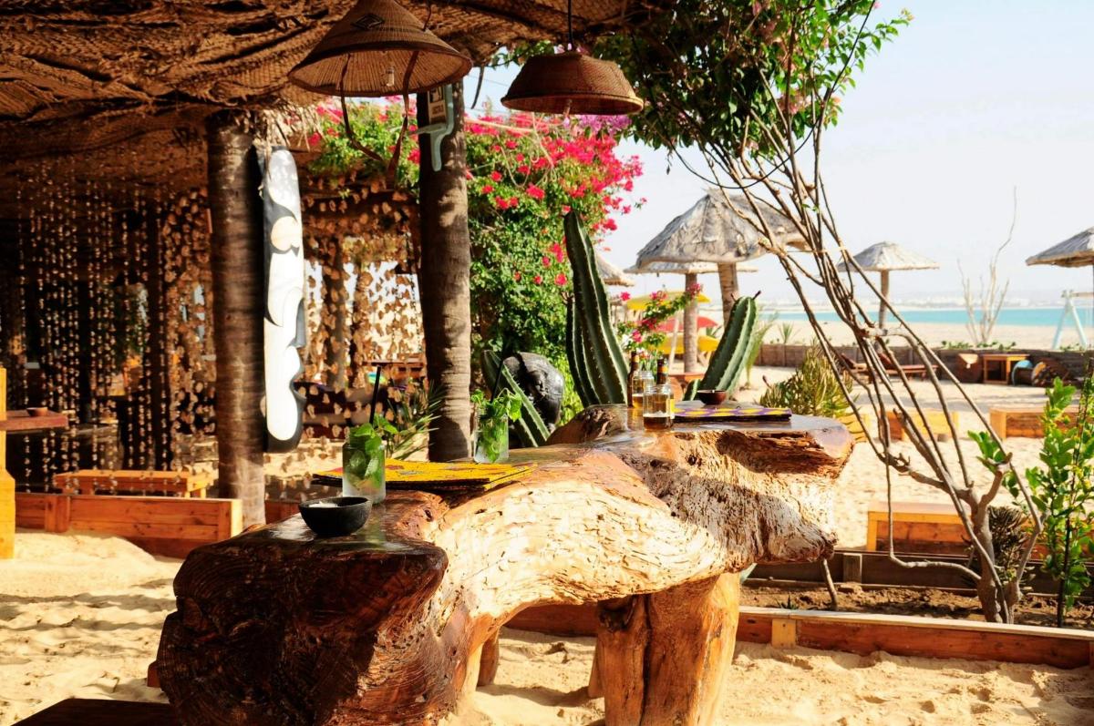 a table with an umbrella on the beach