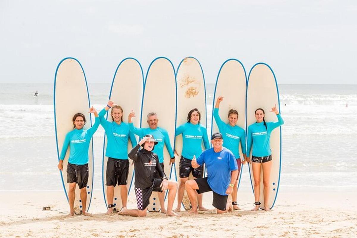 a group of people standing on the beach with surfboards