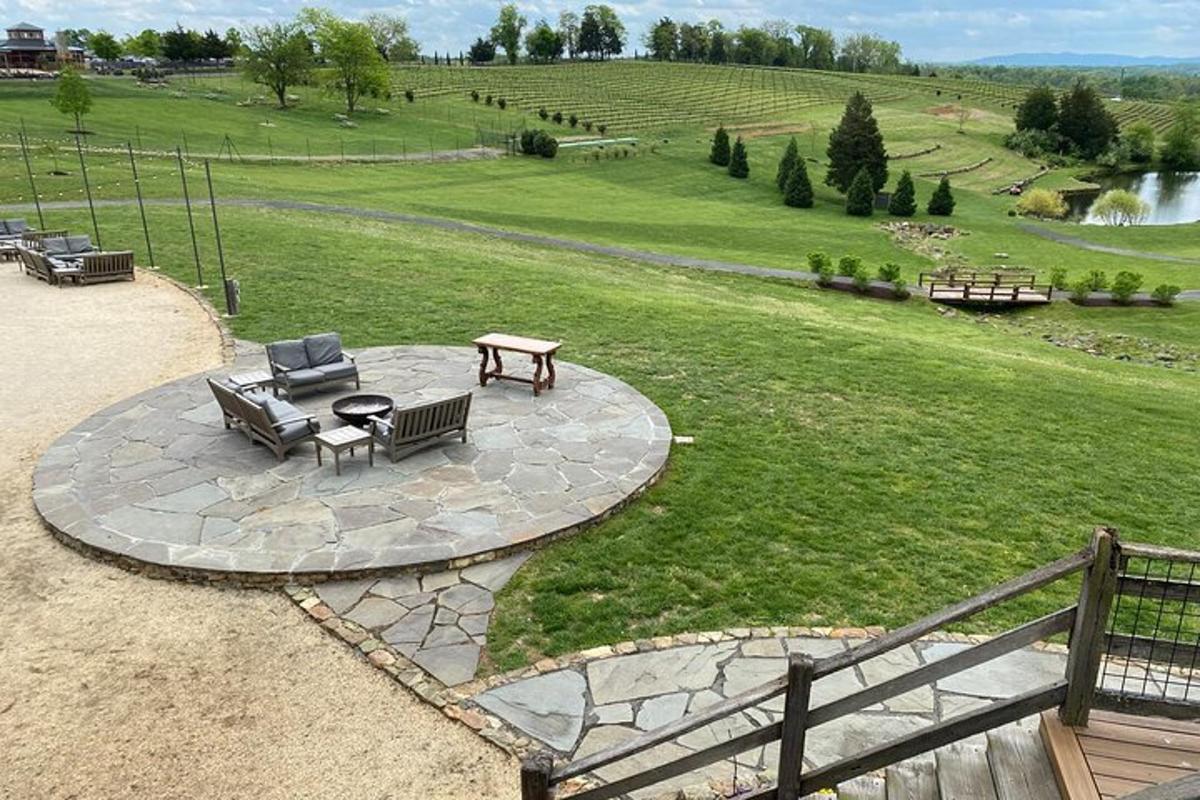 a patio with a bench and a table in a field