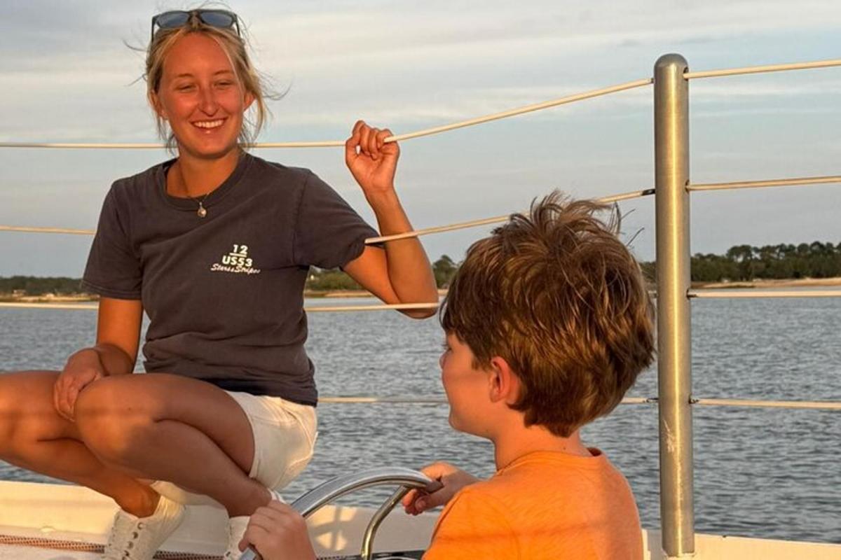 a woman and a boy sitting on a boat