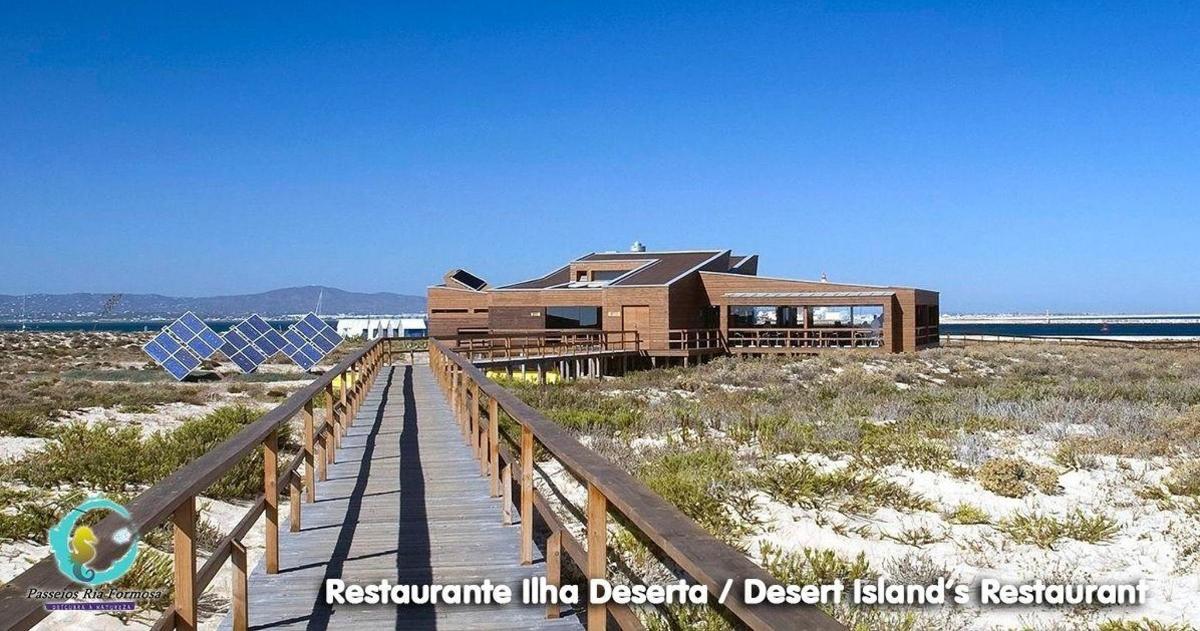 a house on a wooden walkway to the beach