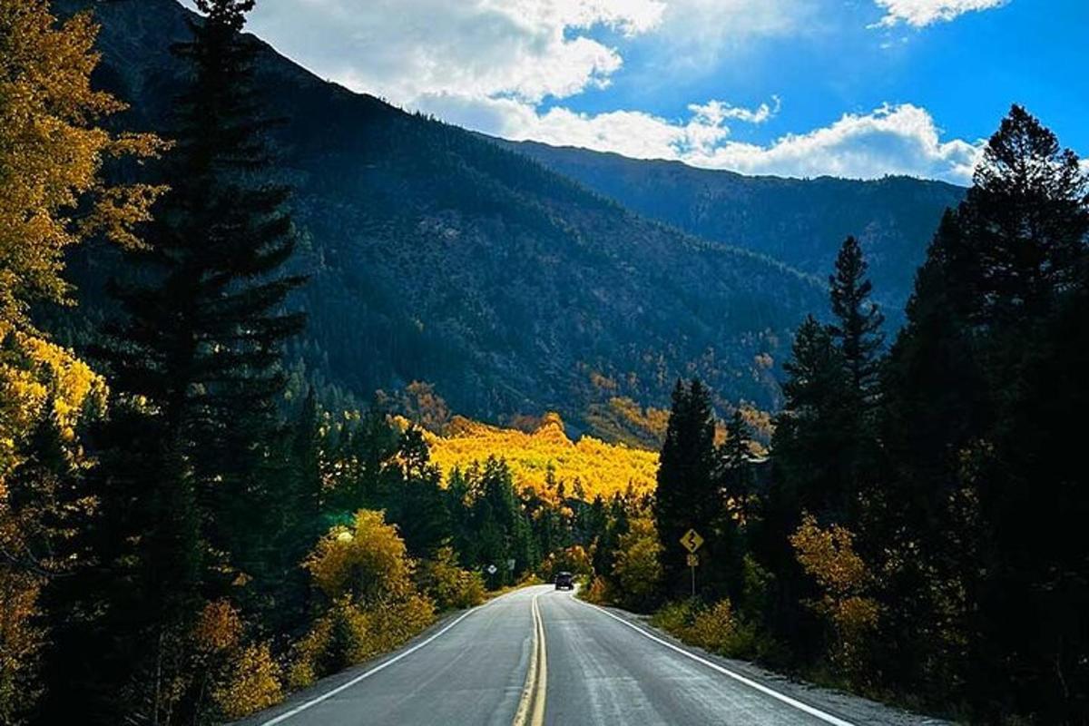 an empty road in the middle of a mountain