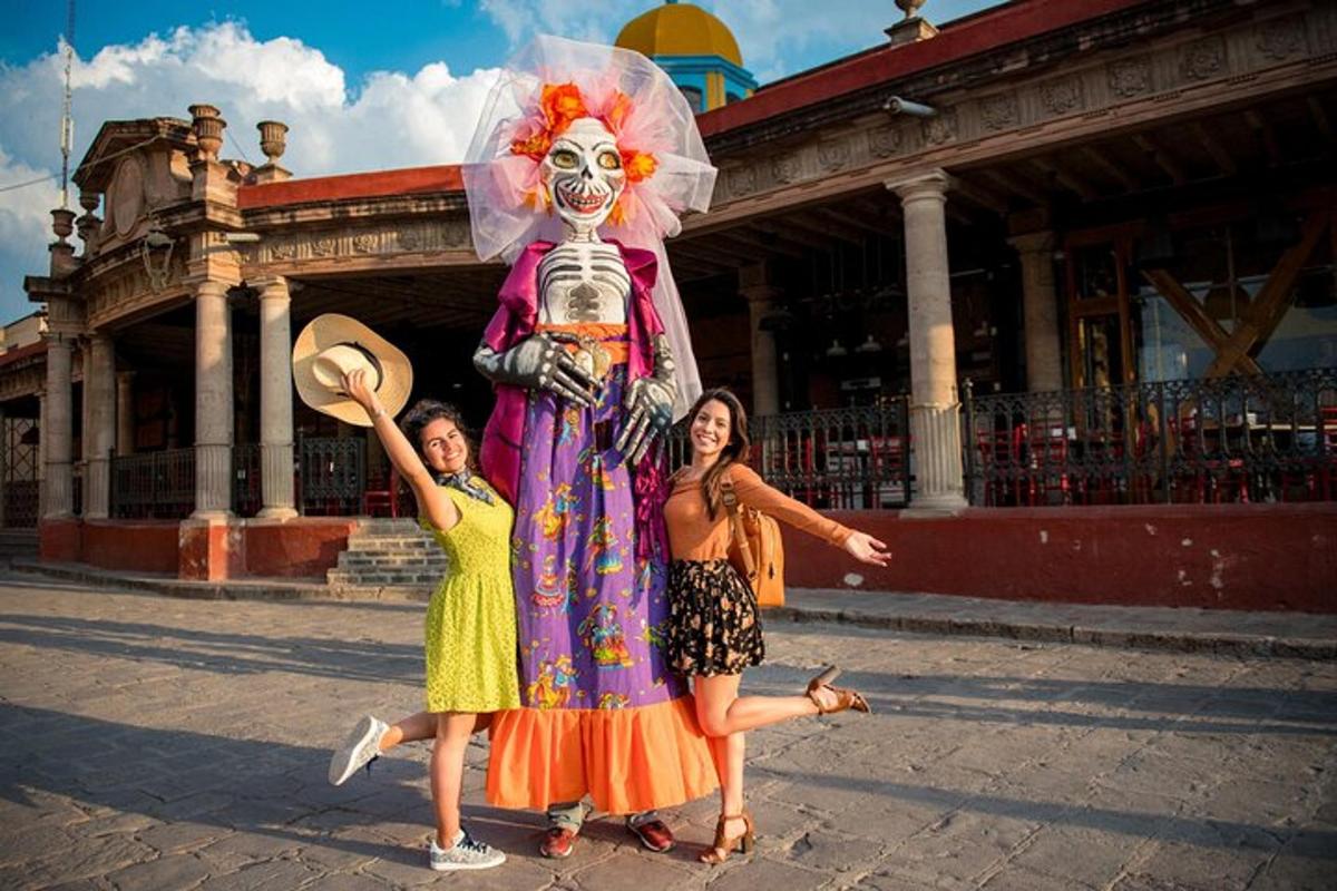a group of girls standing around a statue of a skeleton