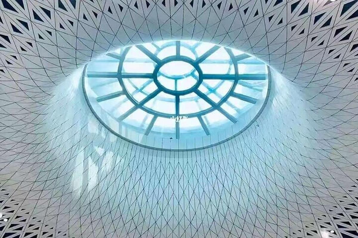 a glass ceiling with a window in a building