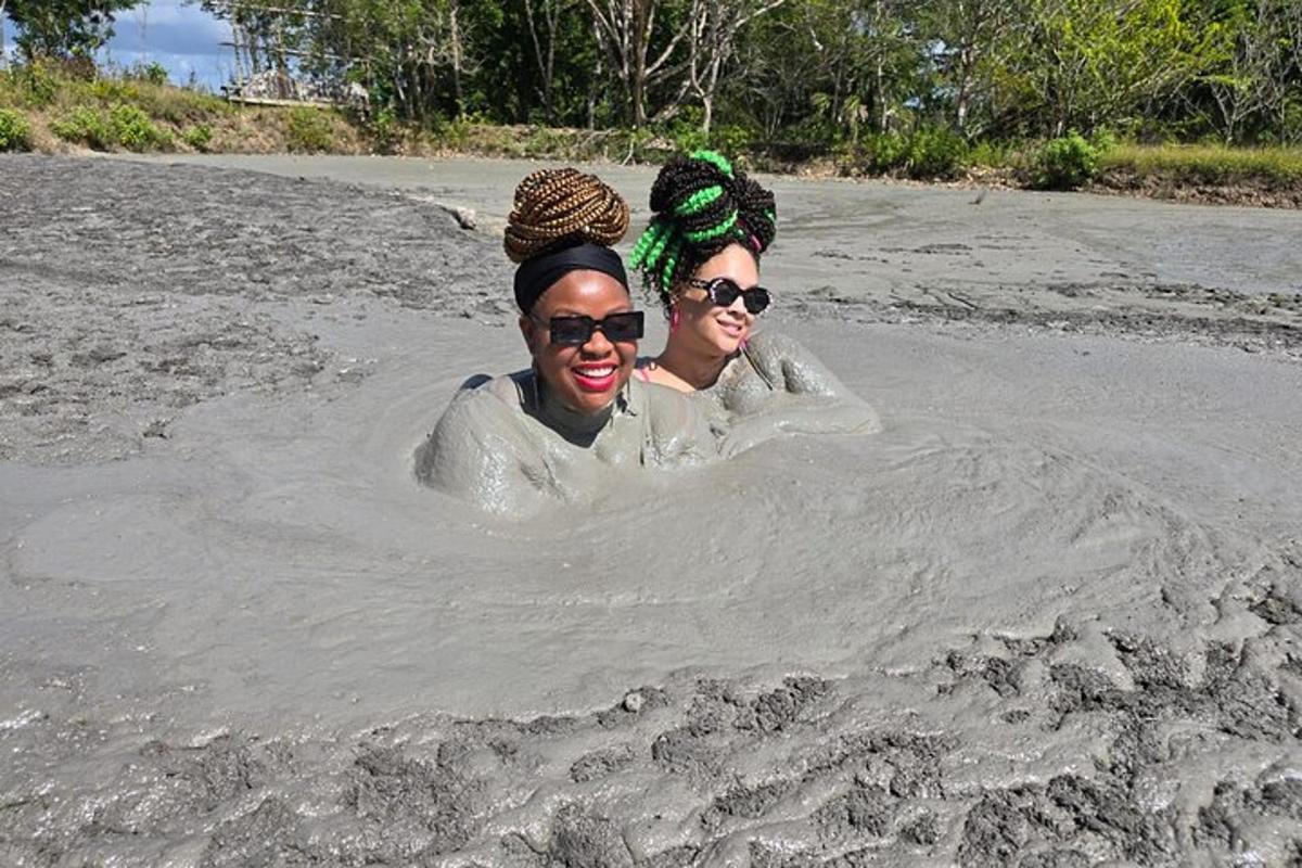 two women are standing in a hole in the sand