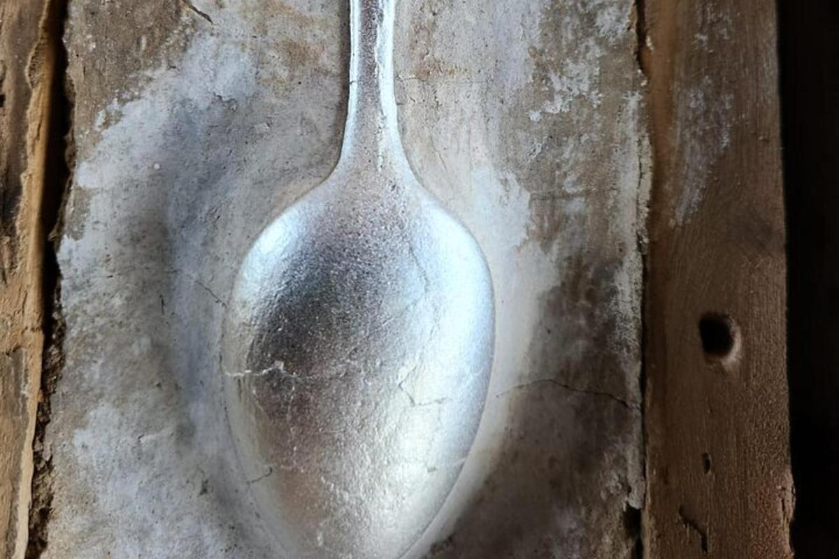a silver spoon sitting on top of a table