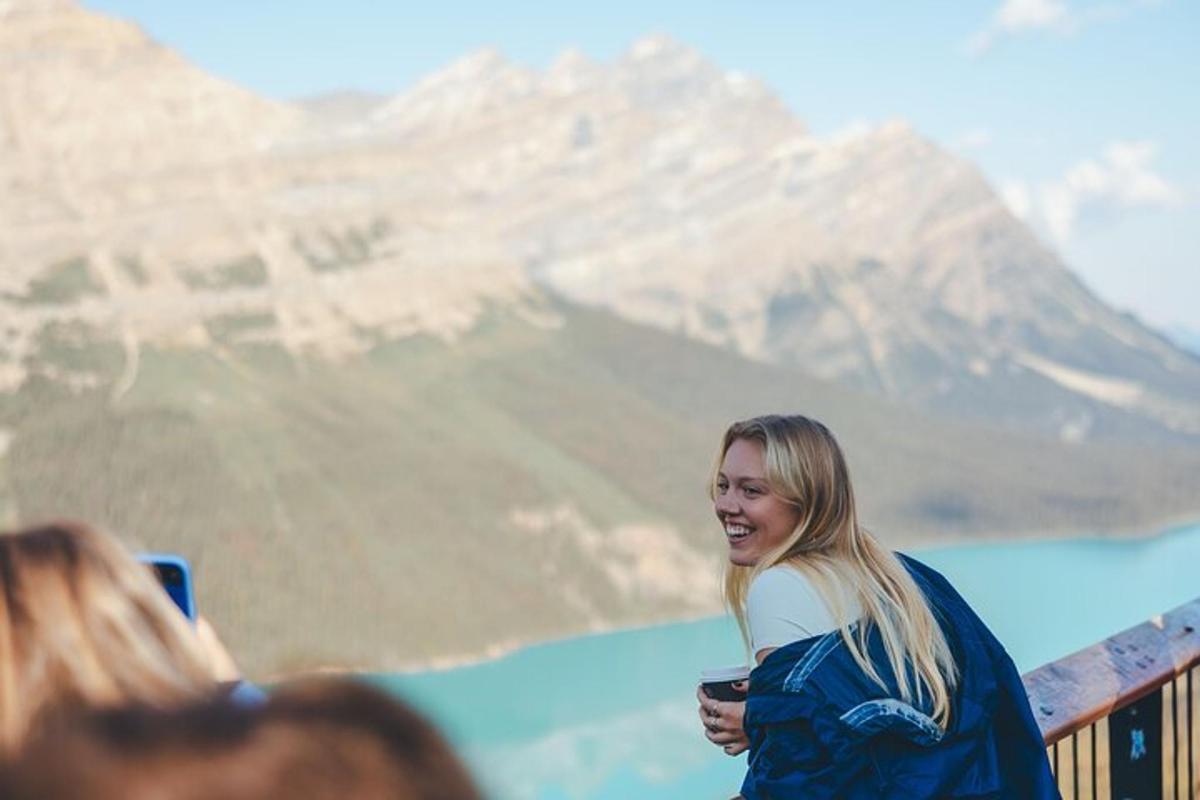 a woman standing on a bridge with a mountain in the background