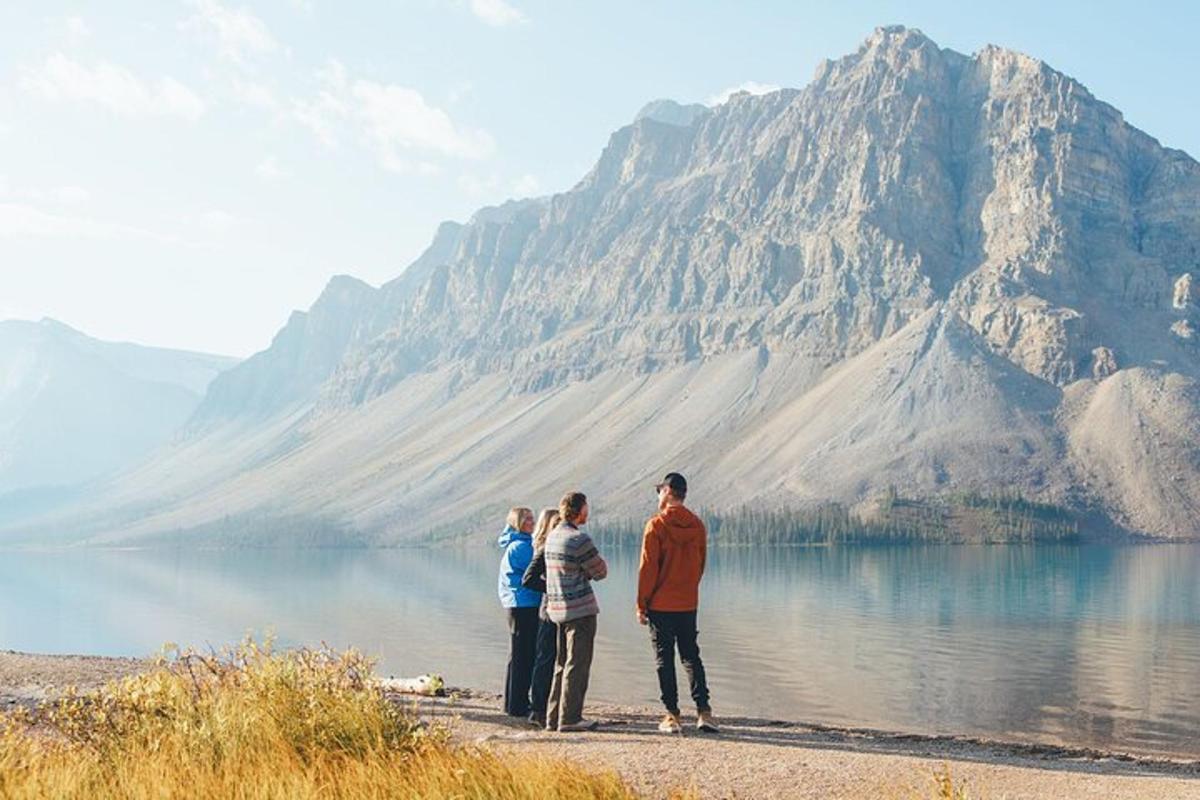 a group of people standing in front of a mountain