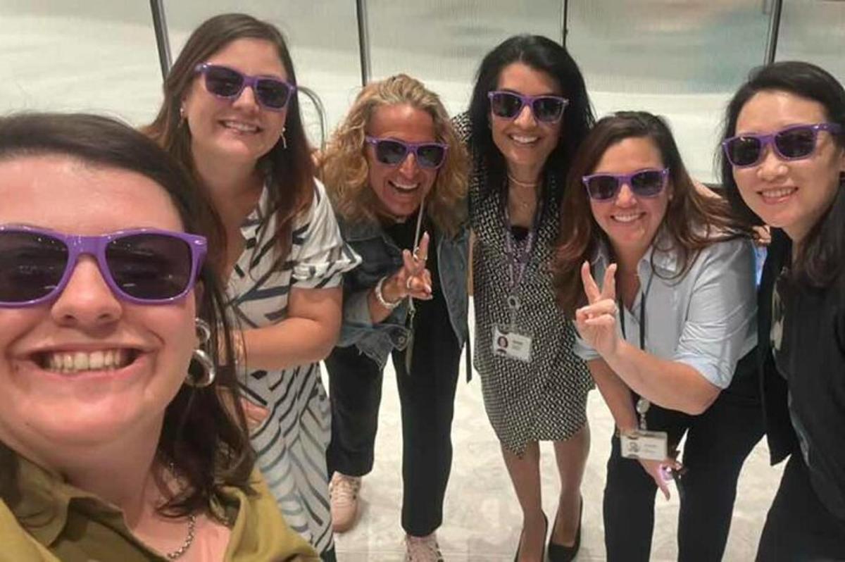a group of women in sunglasses posing for a picture
