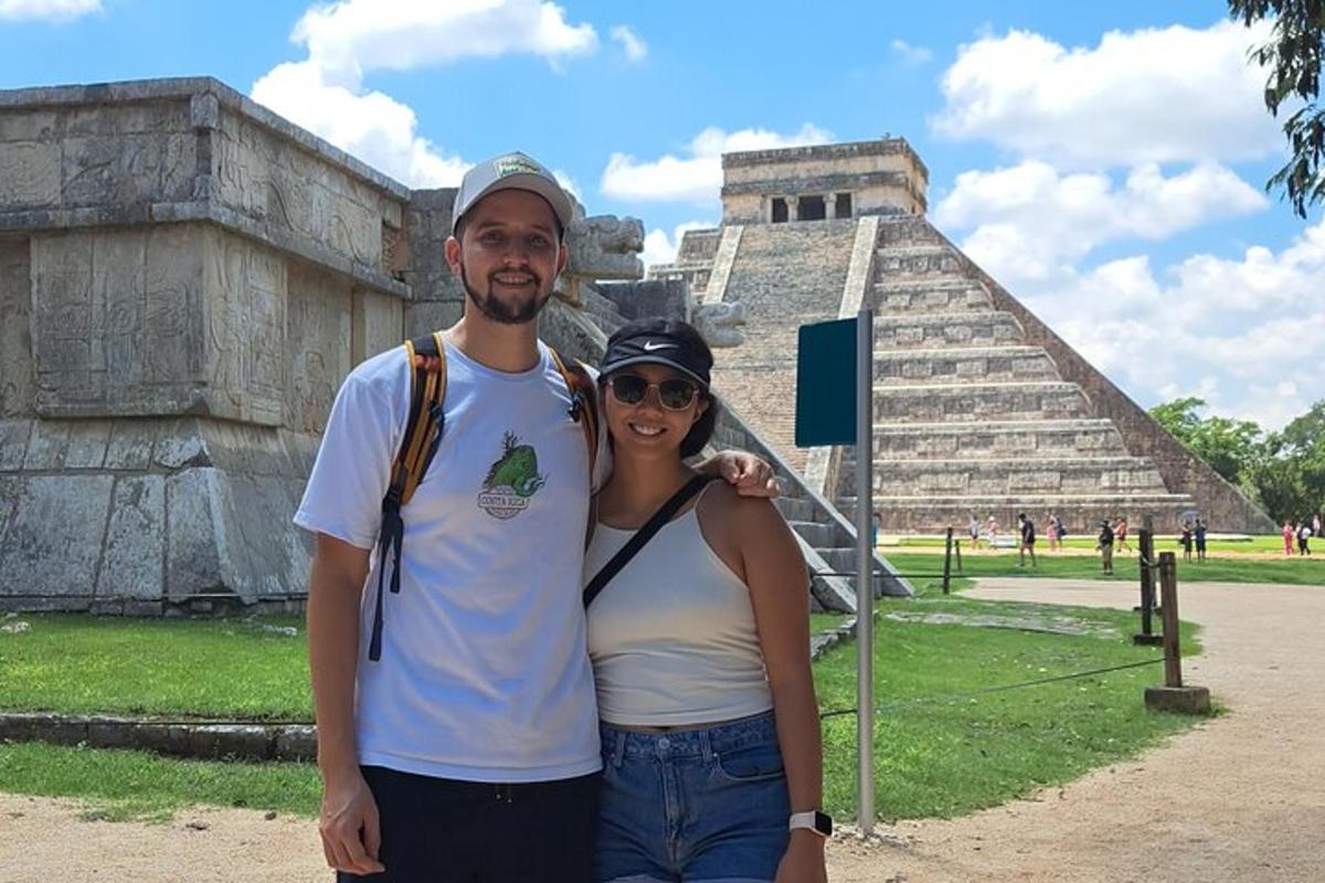 a man and a woman standing in front of a pyramid