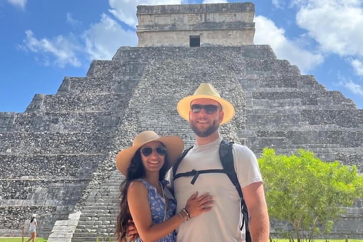 a man and a woman standing in front of a pyramid