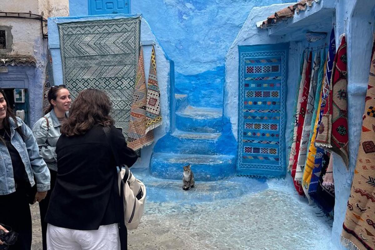 a group of people standing in front of a blue wall