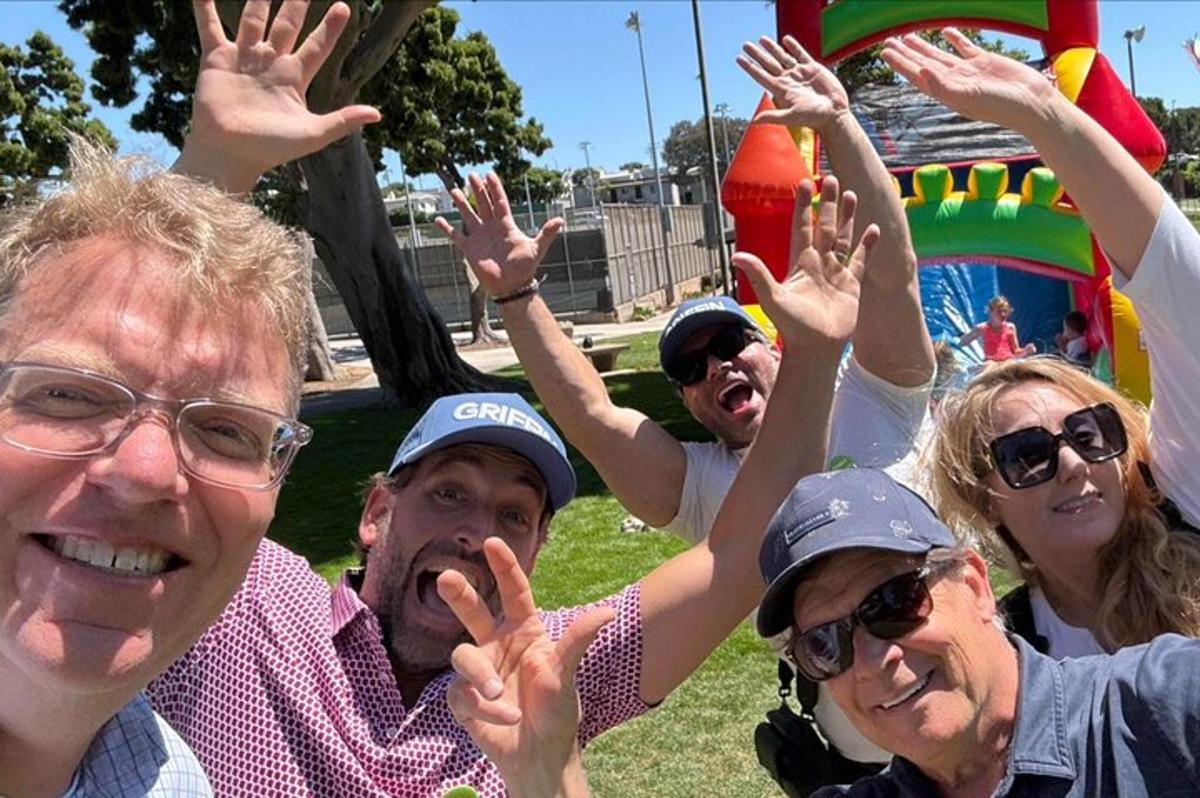 a group of people with their hands in the air
