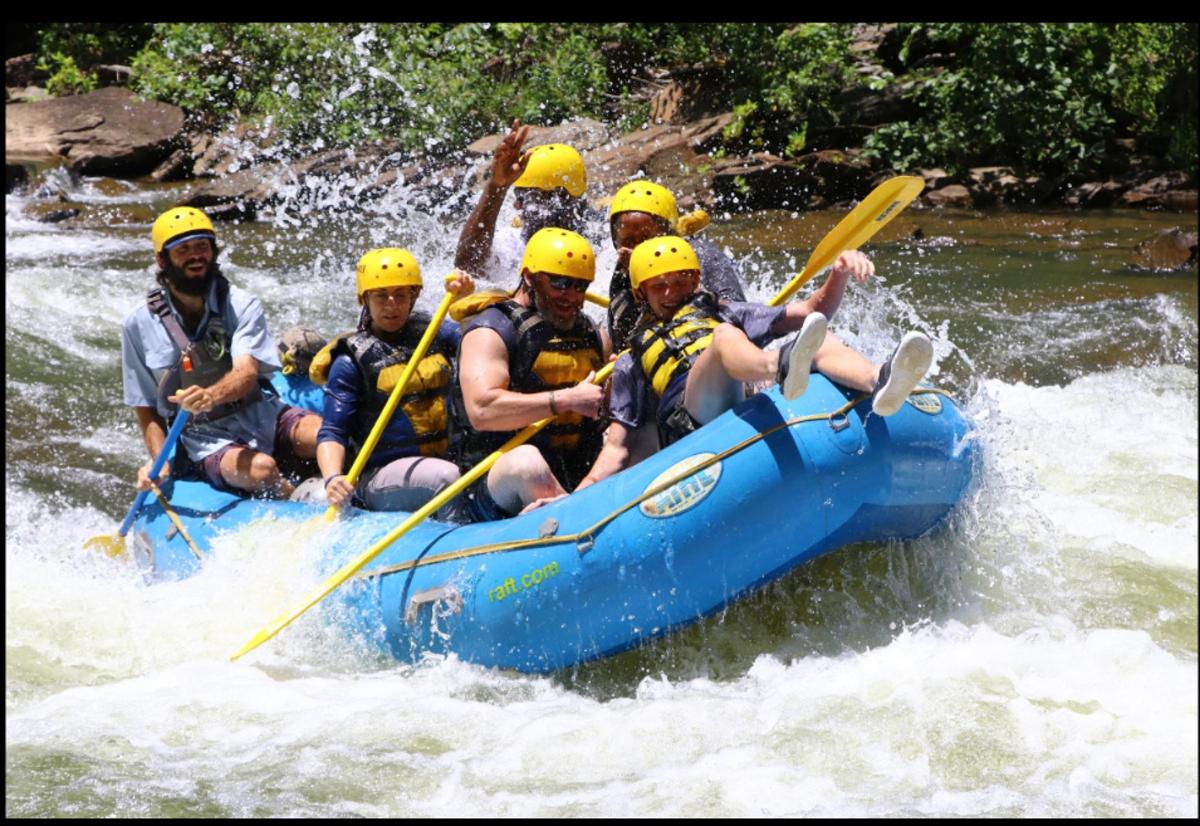 a group of people in a raft on a river