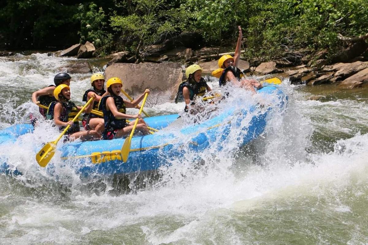 a group of people on a raft in a river