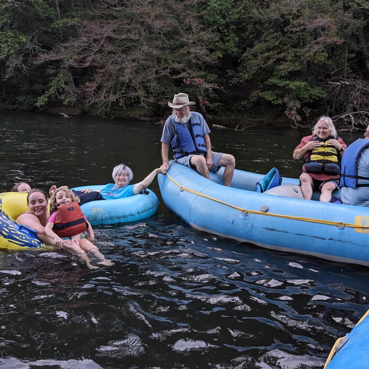 a group of people riding on tubes in the water