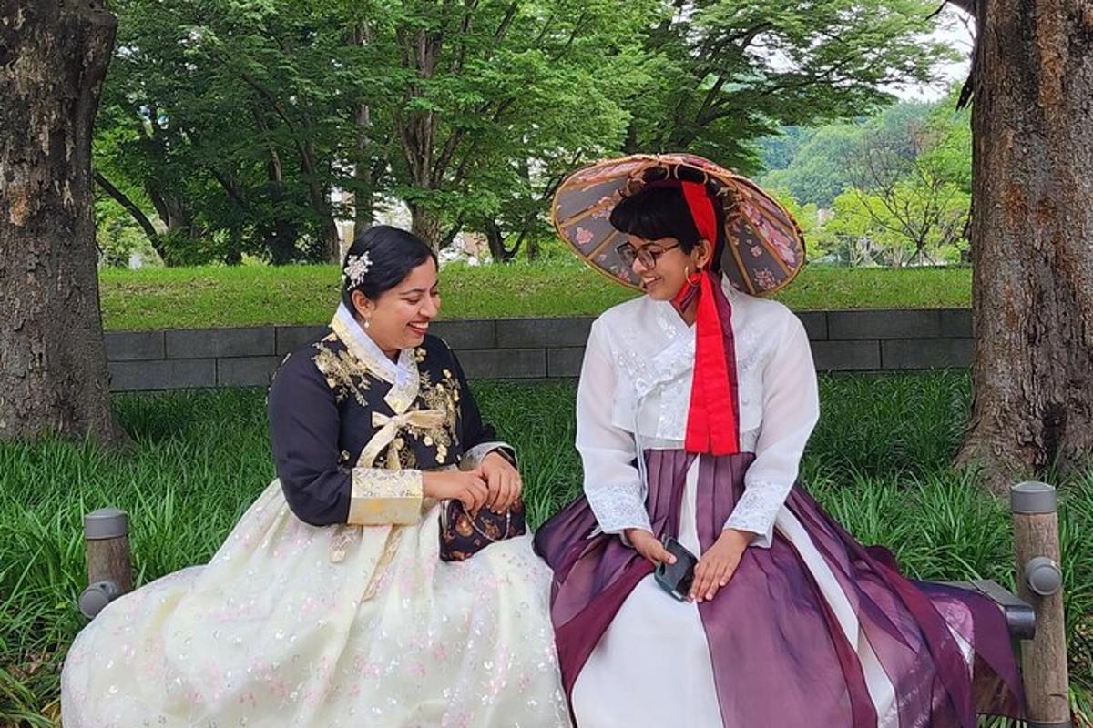 two women in dresses sitting next to each other