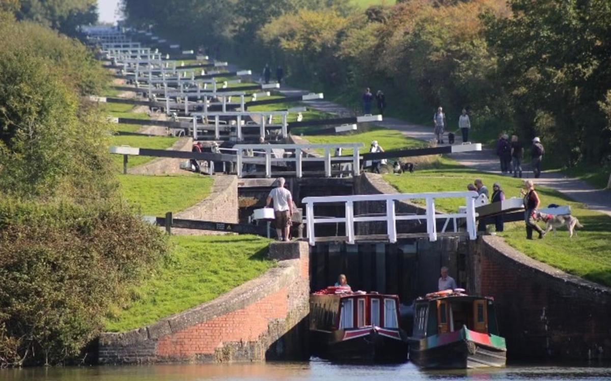 a group of people on boats in a canal