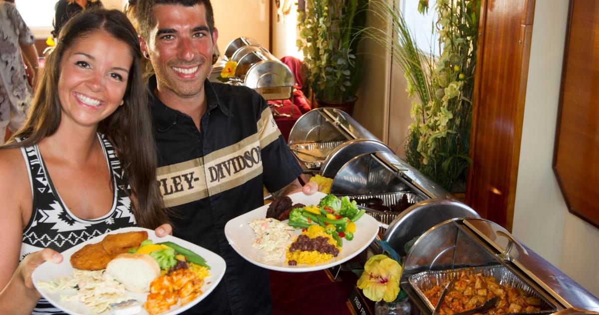 a man and a woman holding plates of food