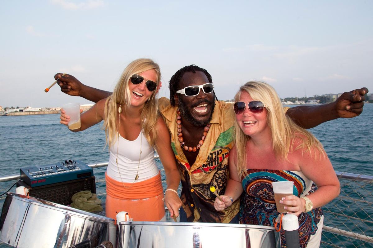a group of three people standing on a boat