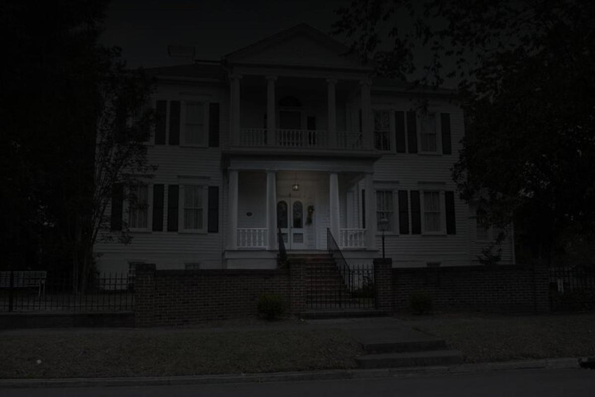 a white house with a porch at night