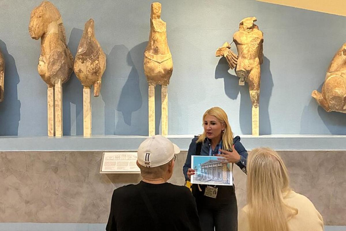 a woman talking to a group of people in a museum