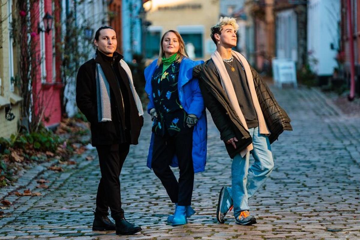 a group of three people walking down a street