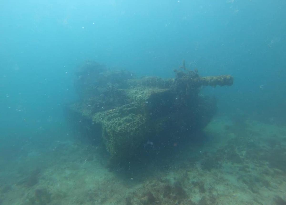 a ship floating in the ocean near the reef