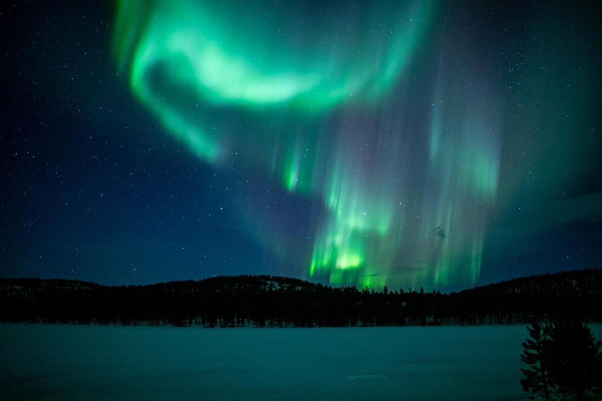 an aurora in the sky over a lake