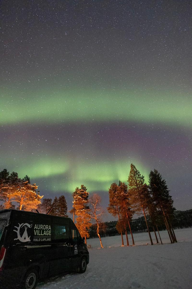 an aurora village van parked in the snow at night