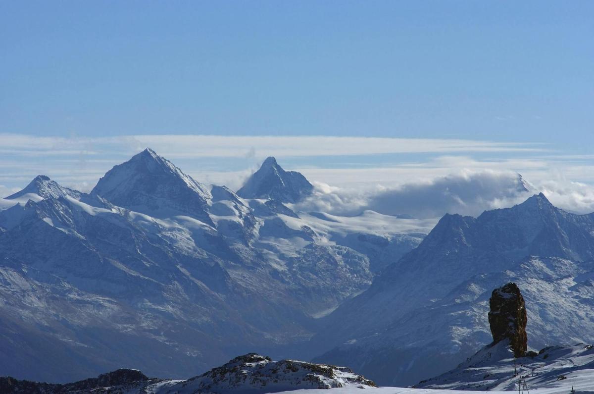 a view of a mountain range with snow covered mountains