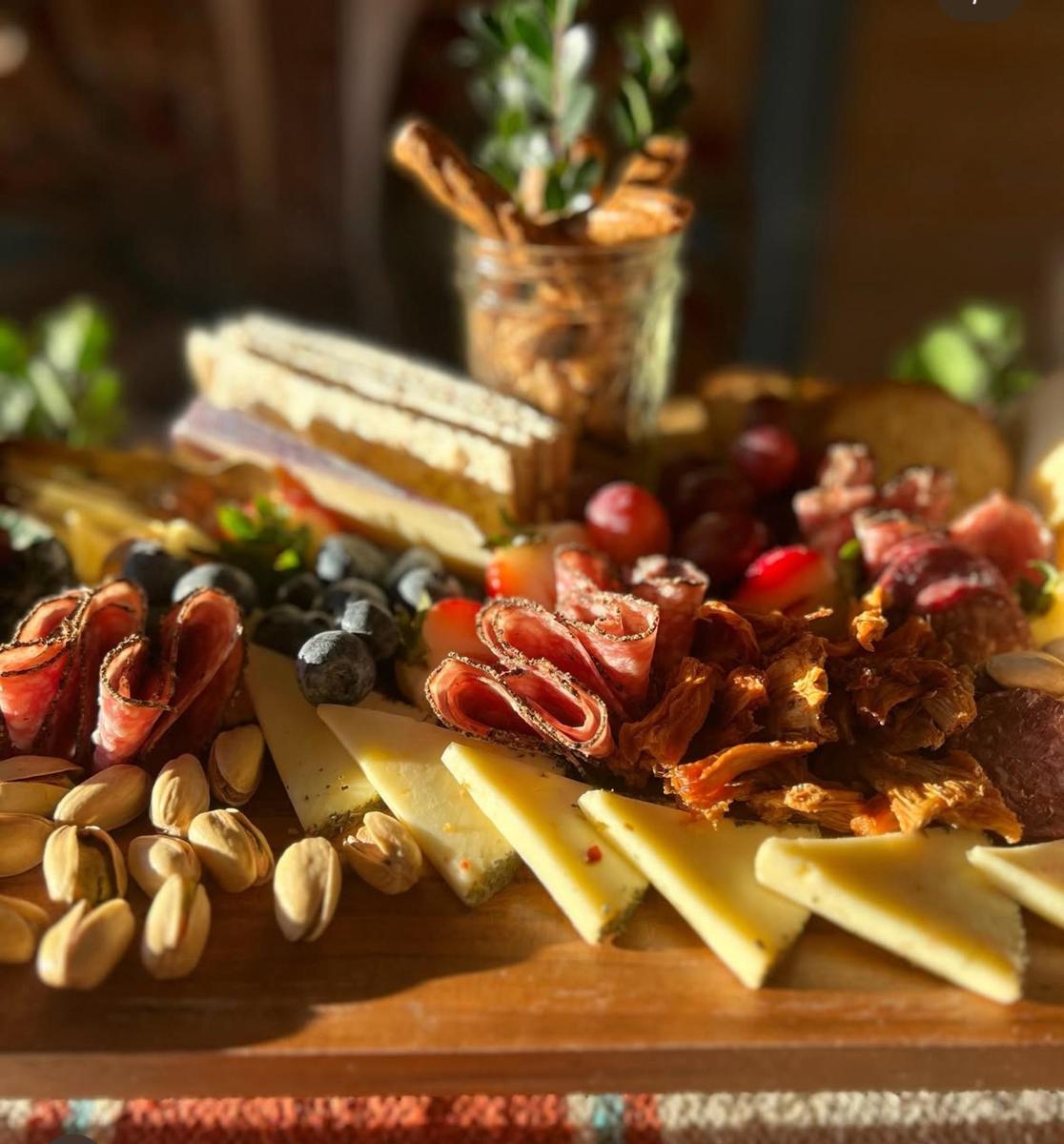 a plate of food with cheese and grapes and nuts